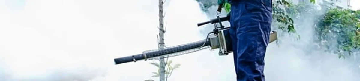 Pest control technician fogging an outdoor area for insect control in Columbus, OH