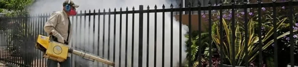Mosquito control technician fogging a yard perimeter for mosquito reduction in Columbus, OH